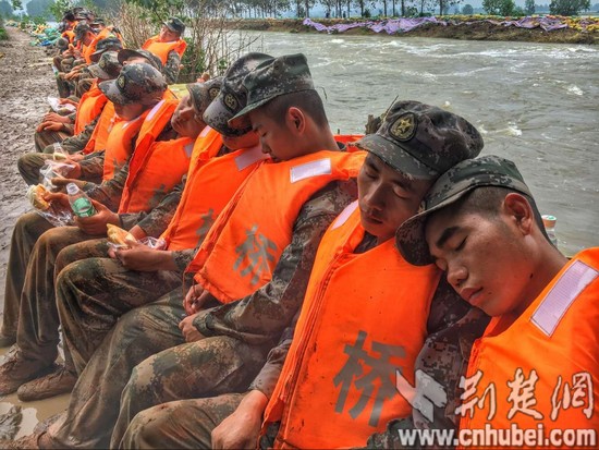 連續(xù)奮戰(zhàn)25小時(shí) 抗洪官兵拿著面包睡著了